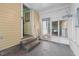Enclosed porch with glass windows and door, providing a cozy transition space at 212 Plum St, Burlington, NC 27215
