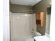 Functional bathroom featuring a shower-tub combination, a white toilet, and an oak medicine cabinet at 221 Hickory Glen Ln, Durham, NC 27703