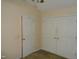 Bedroom featuring closet doors and neutral-toned walls at 221 Hickory Glen Ln, Durham, NC 27703