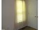 Bedroom with a window covered by sheer curtains and a closet with white paneled doors at 221 Hickory Glen Ln, Durham, NC 27703