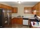 Kitchen with stainless steel refrigerator and appliances, plus wooden cabinets at 221 Hickory Glen Ln, Durham, NC 27703