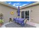 Outdoor patio featuring stylish furniture, decorative elements, and a sliding door to the interior at 272 W Gennessee Dr, Zebulon, NC 27597