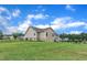 View of a house's sizable backyard with a well-manicured lawn, defined by a sleek black chain-link fence at 272 W Gennessee Dr, Zebulon, NC 27597