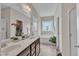 Spacious bathroom with double sinks, a soaking tub, and marble tile flooring at 272 W Gennessee Dr, Zebulon, NC 27597