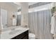 Well-lit bathroom showcasing a sleek vanity, a large mirror, and a shower with a decorative curtain at 272 W Gennessee Dr, Zebulon, NC 27597