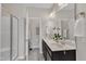Modern bathroom featuring double sinks, marble floors, and walk-in shower at 272 W Gennessee Dr, Zebulon, NC 27597