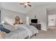 This bedroom has vaulted ceilings, a fan, carpet, and a large dresser at 272 W Gennessee Dr, Zebulon, NC 27597