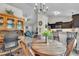 Inviting dining area featuring a round wooden table, chairs, and adjacent kitchen with dark wood cabinetry at 272 W Gennessee Dr, Zebulon, NC 27597