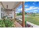 Charming front porch with wooden flooring and support beams, complemented by decorative plants and outdoor furniture at 272 W Gennessee Dr, Zebulon, NC 27597