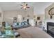 Spacious living room featuring plush sofas, vaulted ceiling, and cozy fireplace, perfect for relaxation at 272 W Gennessee Dr, Zebulon, NC 27597