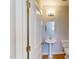 Stylish half bathroom featuring a pedestal sink and modern fixtures at 2735 Hunter Woods Dr # 571, Apex, NC 27502