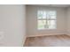 Neutral bedroom with a large window for natural light and neutral carpet at 2735 Hunter Woods Dr # 571, Apex, NC 27502