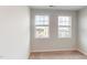This bedroom features plush carpeting, neutral walls, and two bright windows at 2735 Hunter Woods Dr # 571, Apex, NC 27502