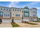 Modern townhome exteriors boast individual character through unique color schemes and stone detailing at 2735 Hunter Woods Dr # 571, Apex, NC 27502