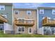 Exterior shot of colorful two-story homes with balconies and grassy backyard at 2735 Hunter Woods Dr # 571, Apex, NC 27502
