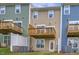 Rear view of townhomes showing private balconies and well-maintained yards at 2735 Hunter Woods Dr # 571, Apex, NC 27502