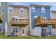 Exterior view of two-story homes featuring balconies and a grassy backyard at 2735 Hunter Woods Dr # 571, Apex, NC 27502