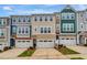 Charming townhomes showcase a mix of neutral siding and stone accents, creating an inviting street view at 2735 Hunter Woods Dr # 571, Apex, NC 27502