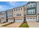 A row of inviting townhomes feature coordinated color palettes and well-manicured landscaping at 2735 Hunter Woods Dr # 571, Apex, NC 27502