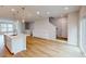 Open-concept living space with kitchen island, and access to the stairs at 2735 Hunter Woods Dr # 571, Apex, NC 27502