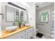Modern bathroom with double sinks, butcher block countertop, and a window at 2809 Titleist Dr, Hillsborough, NC 27278