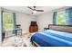 Bedroom with ceiling fan, two windows, wood furniture, and blue bedspread at 2809 Titleist Dr, Hillsborough, NC 27278