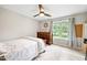 Cozy bedroom with natural light, ceiling fan and warm wood accents at 2809 Titleist Dr, Hillsborough, NC 27278