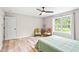 Comfortable bedroom features a ceiling fan, large windows and neutral decor at 2809 Titleist Dr, Hillsborough, NC 27278