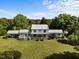Sprawling estate featuring two story home, with a covered car port, and rear balcony overlooking lush landscaping at 301 W Thorndale Dr, Oxford, NC 27565