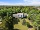 Aerial view of a sprawling home with manicured lawns, surrounded by lush trees, offering both privacy and curb appeal at 301 W Thorndale Dr, Oxford, NC 27565