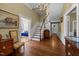 Foyer featuring detailed stairs, hardwood floors, and views into the living room at 301 W Thorndale Dr, Oxford, NC 27565