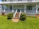 Charming covered porch with white columns, decorative railings, and inviting seating areas at 301 W Thorndale Dr, Oxford, NC 27565