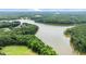 Breathtaking aerial view of a vast lake surrounded by lush green forests and fields at 310 Hidden Lake Dr, Youngsville, NC 27596