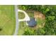 Aerial view of a well maintained home with a circular drive situated on a private lot with mature trees at 310 Hidden Lake Dr, Youngsville, NC 27596