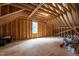 Unfinished attic space with exposed wood beams offering potential for future expansion or storage at 310 Hidden Lake Dr, Youngsville, NC 27596
