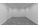 A clean and bright basement with gray carpet and neutral walls at 310 Hidden Lake Dr, Youngsville, NC 27596