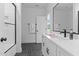 Bright bathroom featuring white tile, a black framed mirror, and walk-in shower at 310 Hidden Lake Dr, Youngsville, NC 27596