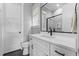 Modern bathroom with white vanity, sleek black hardware, framed mirror, and glass shower at 310 Hidden Lake Dr, Youngsville, NC 27596