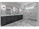 Bathroom features marble tile, and sinks, and a glass-enclosed shower at 310 Hidden Lake Dr, Youngsville, NC 27596