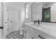 Modern bathroom featuring black and white patterned tile, white cabinetry, and a walk-in shower at 310 Hidden Lake Dr, Youngsville, NC 27596
