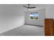Bright bedroom featuring a ceiling fan, gray carpet, and large window with natural light at 310 Hidden Lake Dr, Youngsville, NC 27596
