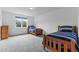 Cozy bedroom with two twin beds, wood frames, and a window offering plenty of natural light at 310 Hidden Lake Dr, Youngsville, NC 27596