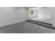 Spacious bonus room with gray carpet, a walk-in closet, and a window at 310 Hidden Lake Dr, Youngsville, NC 27596