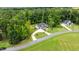 Beautiful two-story home with lush landscaping, circular driveway, and a three-car attached garage at 310 Hidden Lake Dr, Youngsville, NC 27596