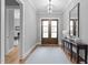 Inviting foyer with hardwood floors, elegant lighting, a decorative table, and access to other rooms at 310 Hidden Lake Dr, Youngsville, NC 27596