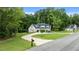 Beautiful two-story home nestled among lush trees, offering both privacy and curb appeal at 310 Hidden Lake Dr, Youngsville, NC 27596