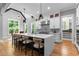 Bright kitchen featuring a large island, stainless steel appliances, and stylish pendant lighting at 310 Hidden Lake Dr, Youngsville, NC 27596