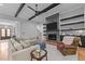 Cozy living room with a modern fireplace, a large sectional sofa, and stylish decor at 310 Hidden Lake Dr, Youngsville, NC 27596