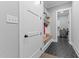 Mudroom entry featuring a bench with hooks, custom shelves, and adjacent laundry room at 310 Hidden Lake Dr, Youngsville, NC 27596