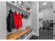 Inviting mudroom with built-in bench, coat hooks, storage, and direct access to the laundry room at 310 Hidden Lake Dr, Youngsville, NC 27596